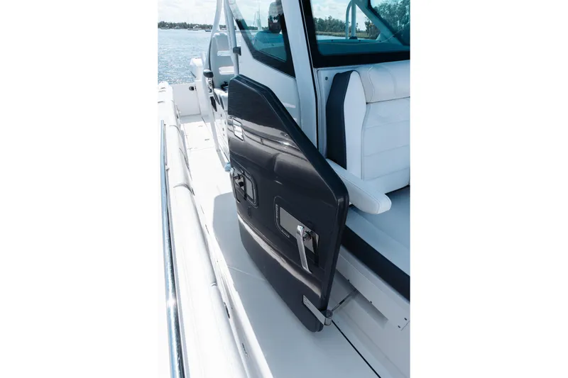 Lickety-split Yacht Photos Pics 2021 Blackfin 332 CC boat with open side door, white seating, and ocean view.