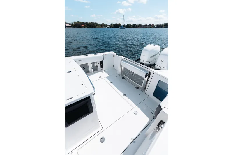 Lickety-split Yacht Photos Pics 2021 Blackfin 332 CC boat deck with twin engines on a calm lake.