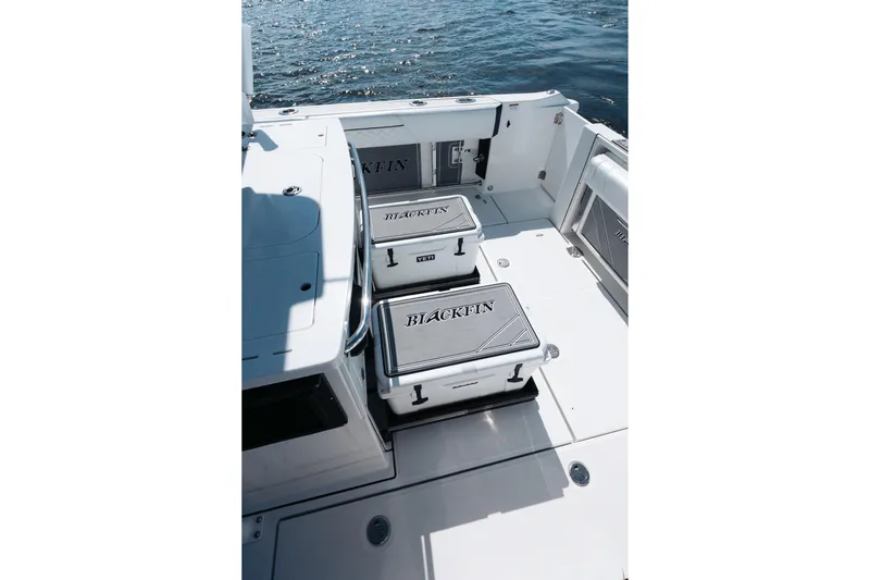 Lickety-split Yacht Photos Pics 2021 Blackfin 332 CC boat deck with storage compartments and ocean view.