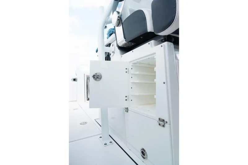 Lickety-split Yacht Photos Pics 2021 Blackfin 332 CC boat interior storage compartment with open door and seating.