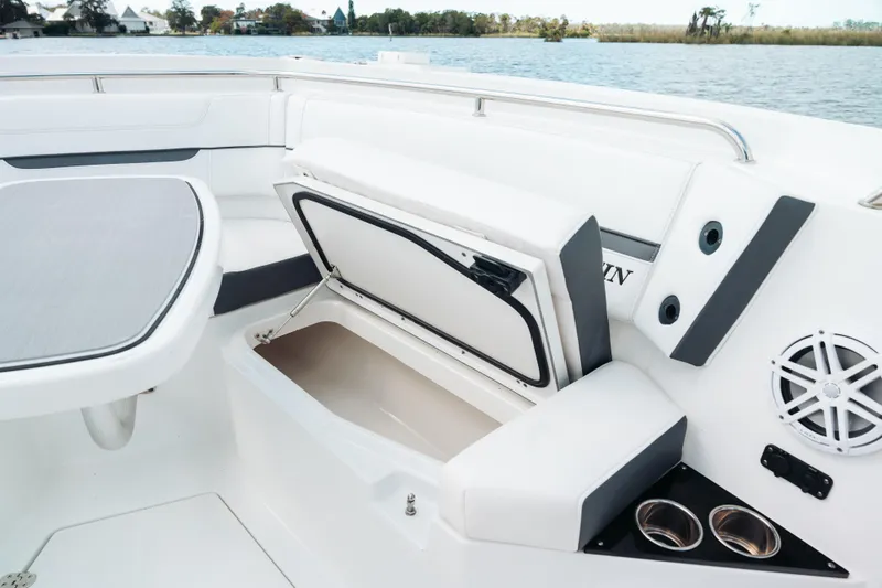 Lickety-split Yacht Photos Pics 2021 Blackfin 332 CC boat interior with open storage compartment and cup holders.