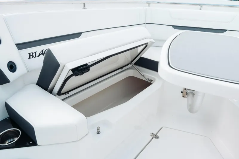 Lickety-split Yacht Photos Pics 2021 Blackfin 332 CC boat interior with open storage compartment and seating area.