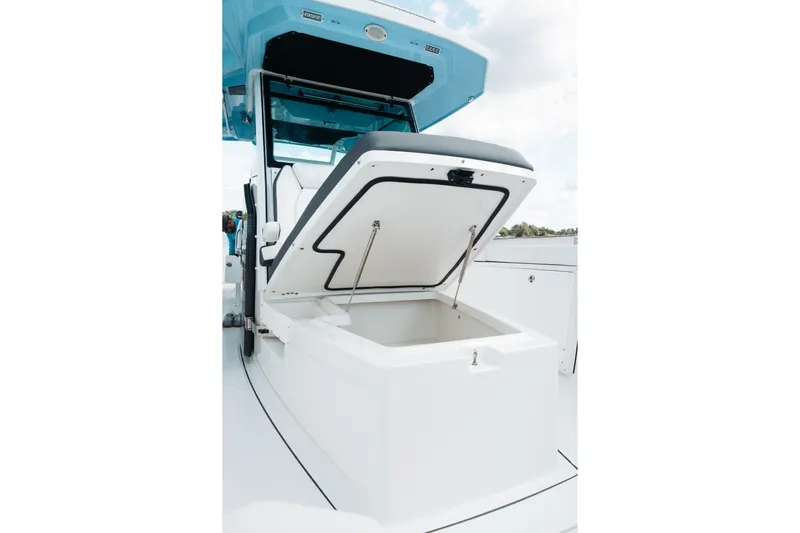 Lickety-split Yacht Photos Pics 2021 Blackfin 332 CC boat with open storage compartment, showcasing sleek design.