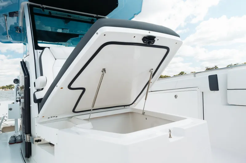 Lickety-split Yacht Photos Pics 2021 Blackfin 332 CC boat with open storage compartment, showcasing sleek design.