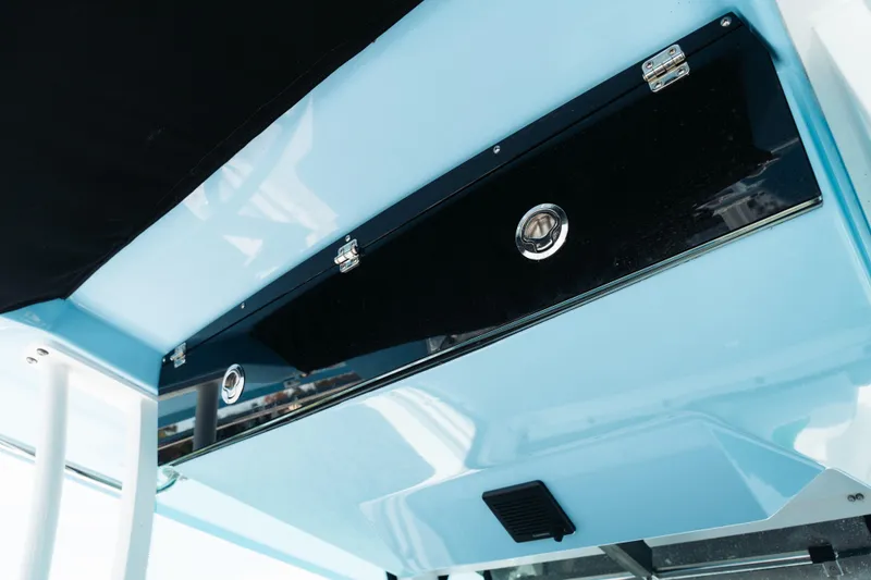 Lickety-split Yacht Photos Pics 2021 Blackfin 332 CC boat interior storage compartment with sleek black and blue design.