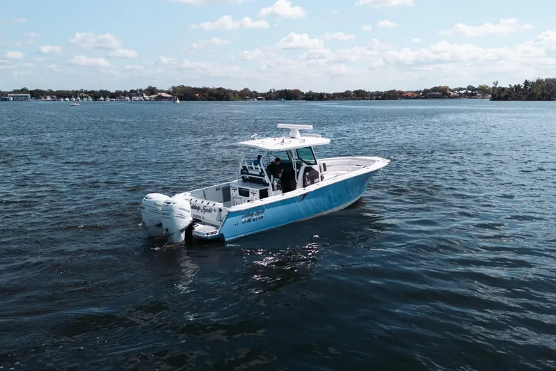 Lickety-split Yacht Photos Pics 2021 Blackfin 332 CC boat on calm water under a clear sky.