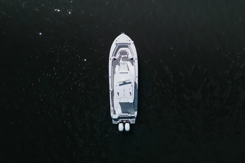 Lickety-split Yacht Photos Pics Aerial view of 2021 Blackfin 332 CC boat on dark water.
