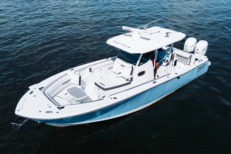 Lickety-split Yacht Photos Pics 2021 Blackfin 332 CC boat on water, featuring sleek design and dual engines.