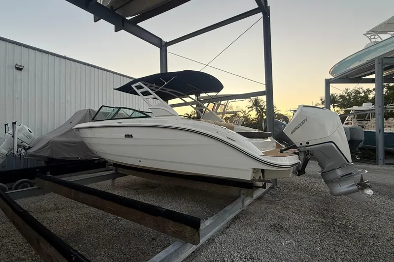  Yacht Photos Pics 2025 Sea Ray SDX 270 Outboard boat on trailer, parked in a marina at sunset.