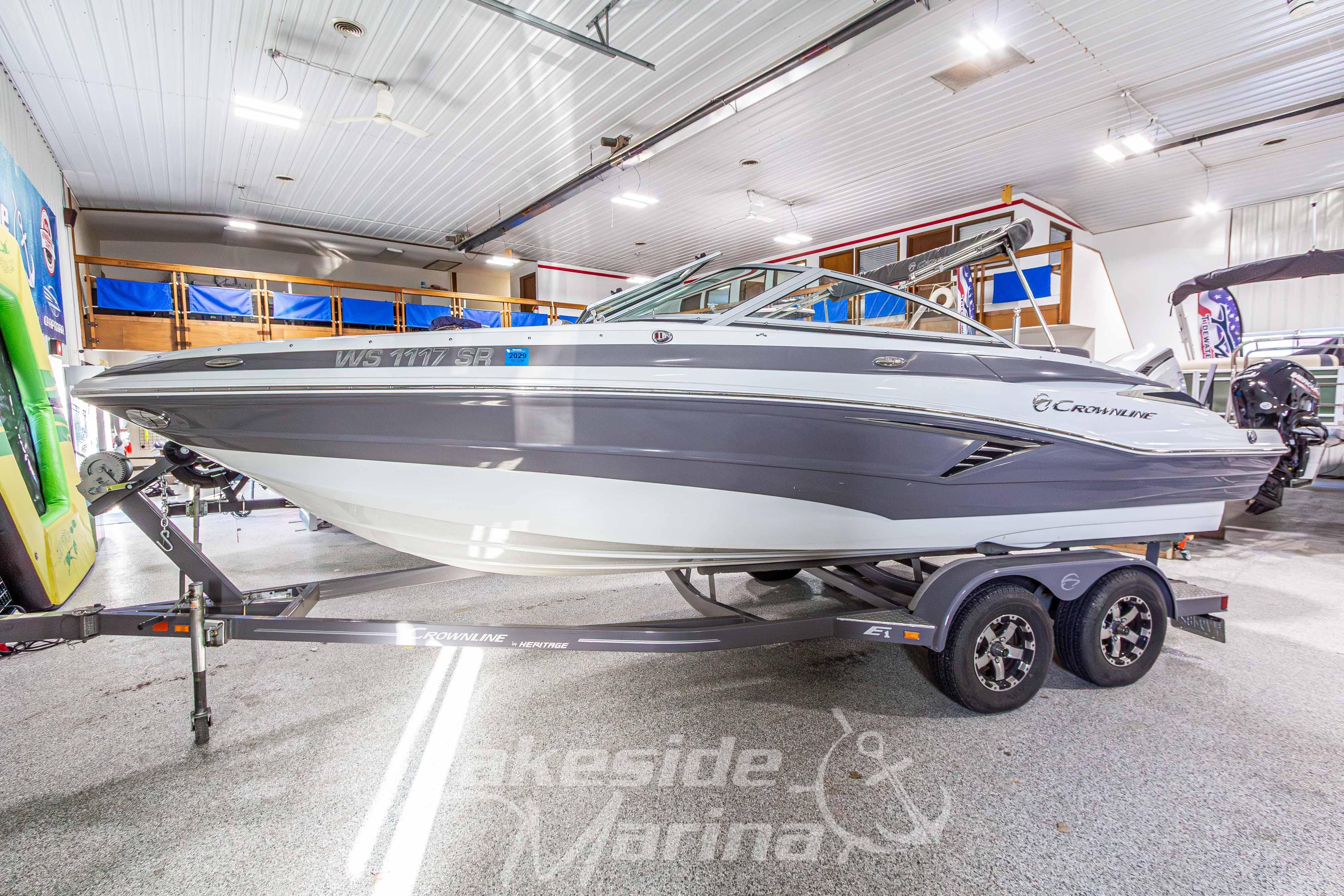 2017 Crownline Eclipse E1 XS boat on trailer in indoor showroom.