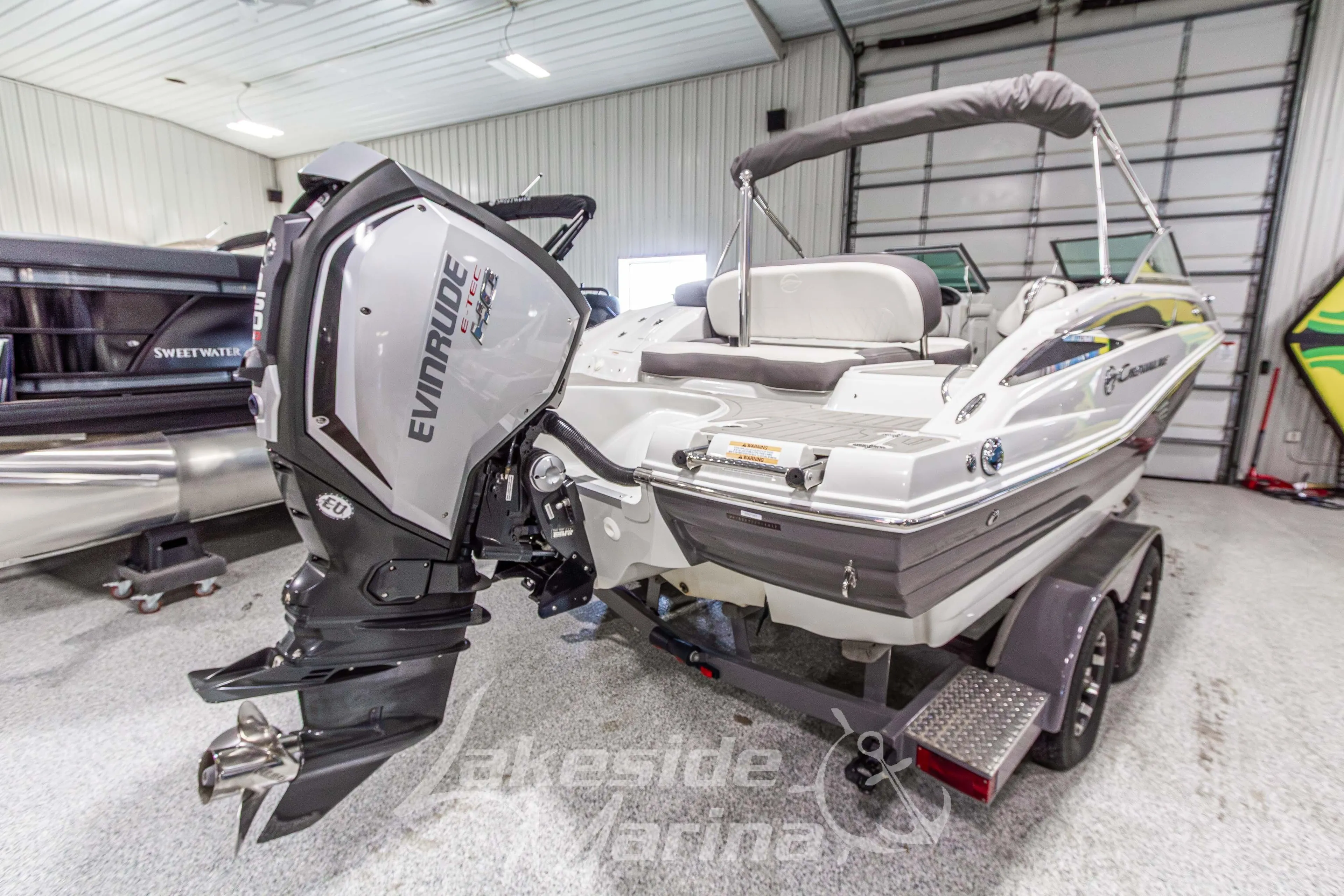 2017 Crownline Eclipse E1 XS boat with Evinrude engine in indoor showroom.