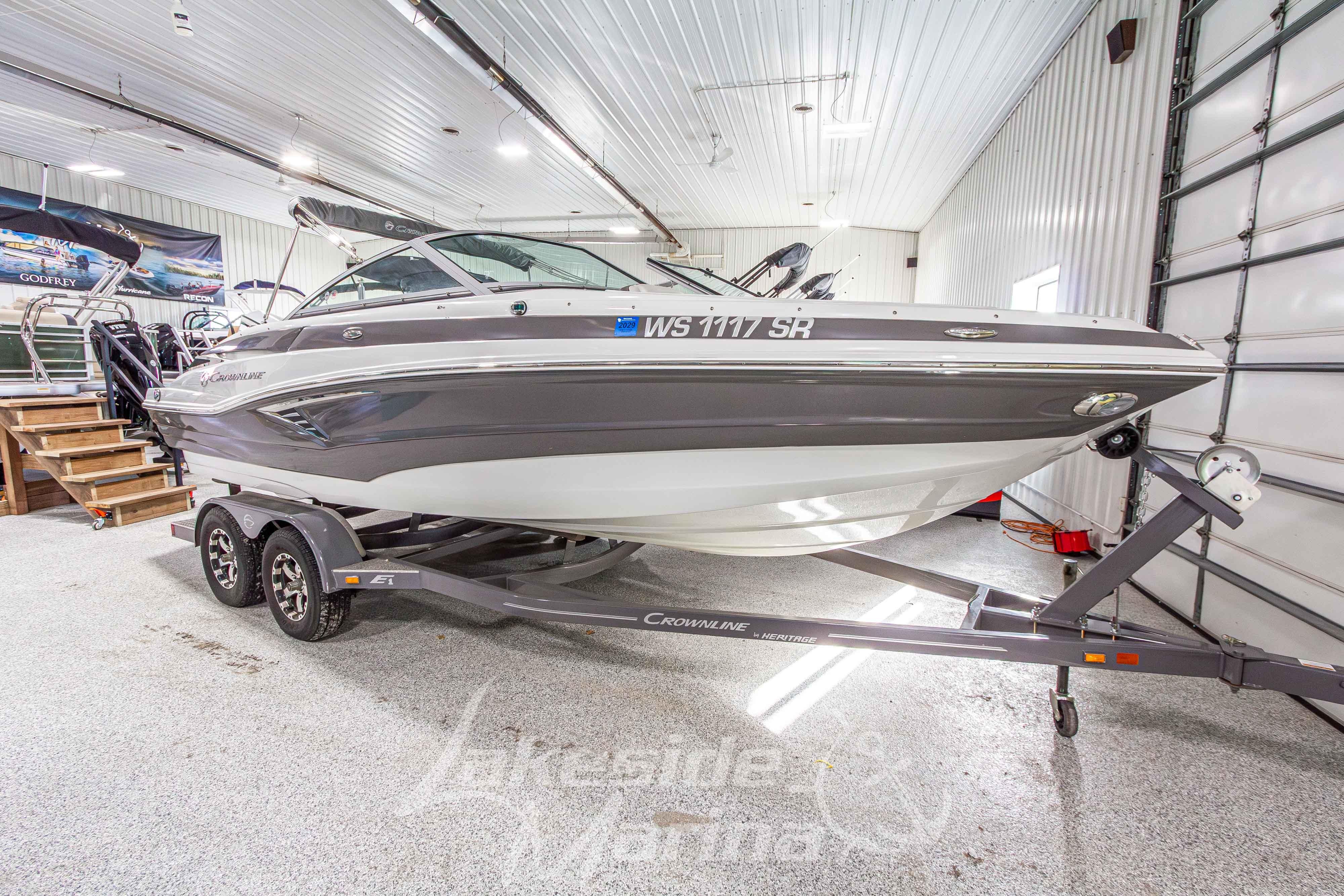 2017 Crownline Eclipse E1 XS boat on trailer in indoor showroom.