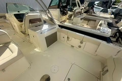  Yacht Photos Pics 2026 Chris-Craft Calypso 28 boat interior with seating and helm, showcasing luxury design.