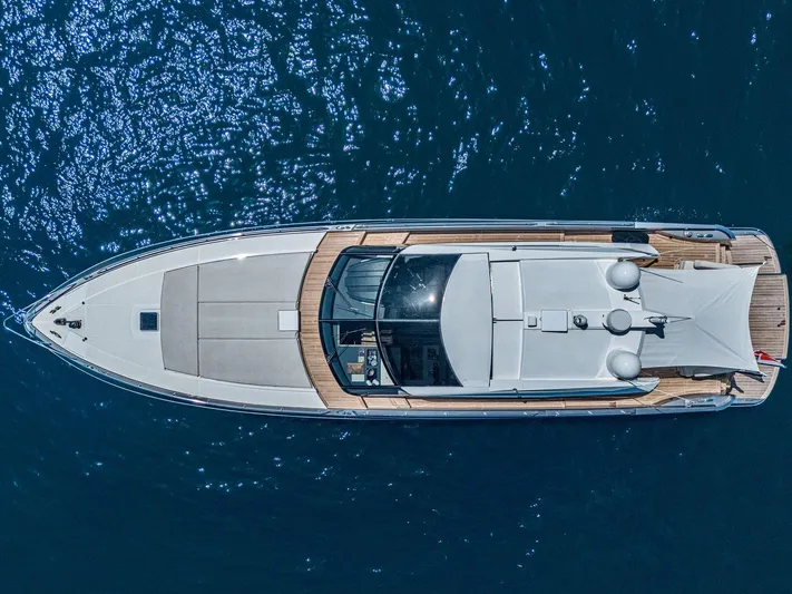 M/y Lioness Yacht Photos Pics Aerial view of 2008 Baia Italia 70 yacht on shimmering blue water.