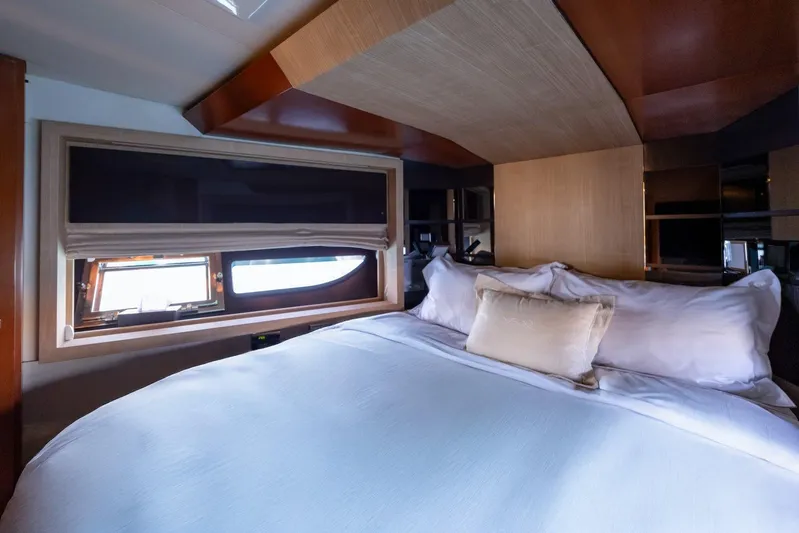 M/y Lioness Yacht Photos Pics Luxurious bedroom interior of 2008 Baia Italia 70 yacht with elegant bedding and window view.