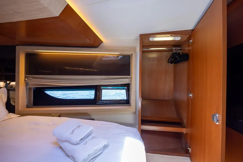 M/y Lioness Yacht Photos Pics Luxurious cabin interior of 2008 Baia Italia 70 yacht with window view and closet.