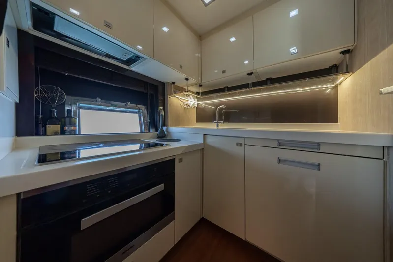 M/y Lioness Yacht Photos Pics Modern kitchen interior in a 2008 Baia Italia 70 yacht, featuring sleek cabinetry and appliances.