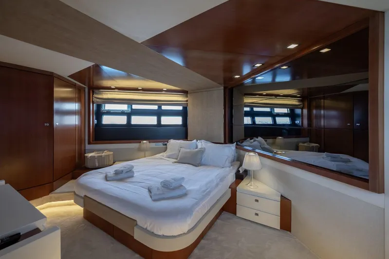 M/y Lioness Yacht Photos Pics Luxurious bedroom interior of 2008 Baia Italia 70 yacht with modern design and elegant furnishings.