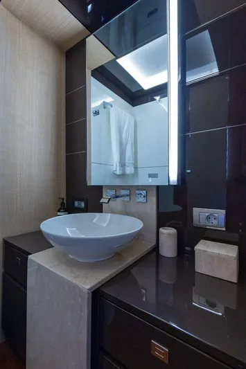 M/y Lioness Yacht Photos Pics Luxurious bathroom in 2008 Baia Italia 70 yacht with modern sink and mirror.