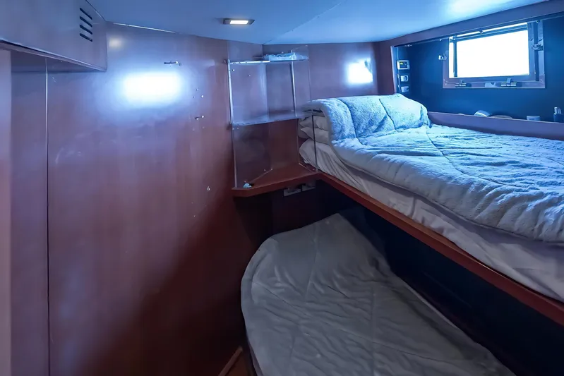 M/y Lioness Yacht Photos Pics Interior of 2008 Baia Italia 70 yacht with cozy bunk beds and wooden paneling.