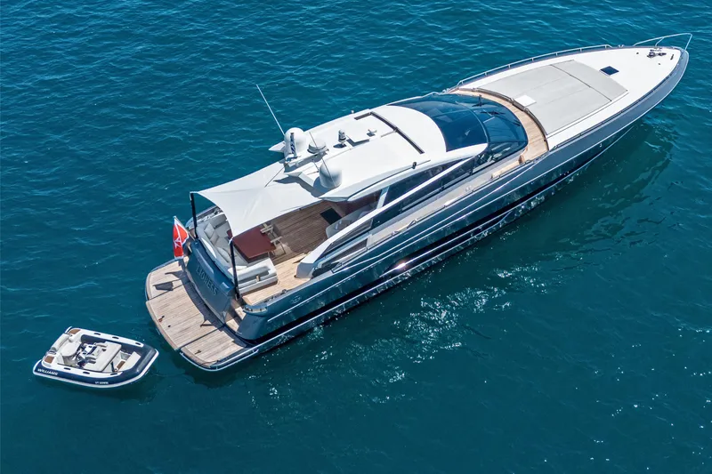 M/y Lioness Yacht Photos Pics Luxurious 2008 Baia Italia 70 yacht on blue ocean, with a small tender boat.