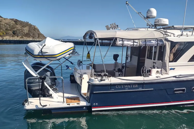 Wyvern Yacht Photos Pics 2020 Cutwater C-32 Coupe boat docked with inflatable dinghy and Yamaha motor.