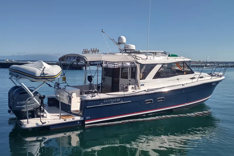 Wyvern Yacht Photos Pics 2020 Cutwater C-32 Coupe boat docked in calm waters, featuring a Yamaha engine.