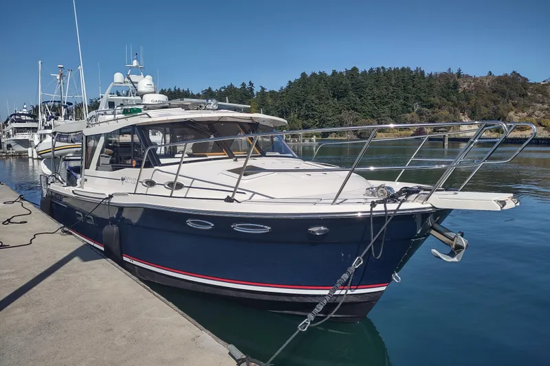 Wyvern Yacht Photos Pics 2020 Cutwater C-32 Coupe docked at a marina with scenic background.