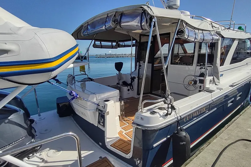 Wyvern Yacht Photos Pics 2020 Cutwater C-32 Coupe docked, showcasing sleek design and spacious deck area.