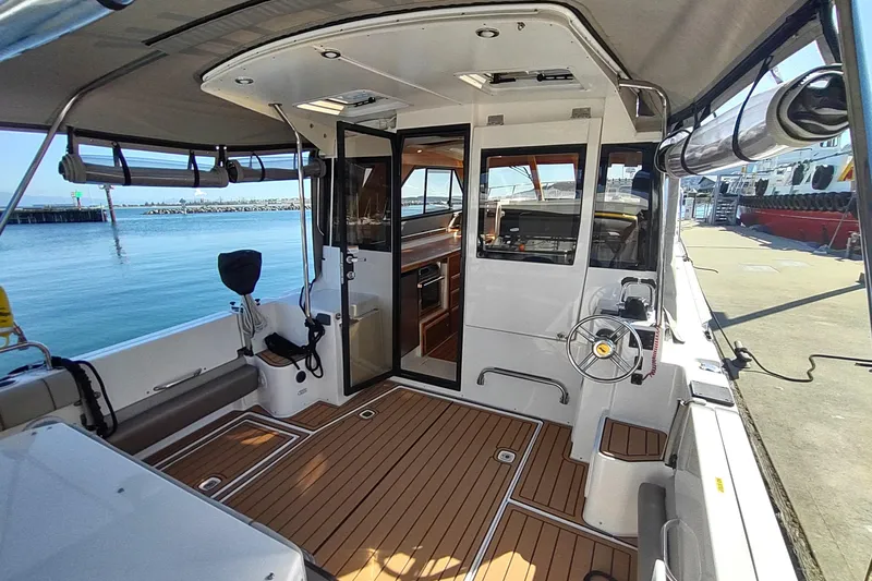 Wyvern Yacht Photos Pics 2020 Cutwater C-32 Coupe boat interior with teak flooring and modern helm.