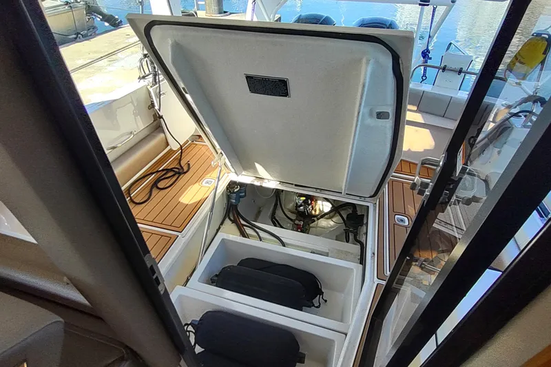 Wyvern Yacht Photos Pics 2020 Cutwater C-32 Coupe boat interior with open storage compartments and visible engine area.