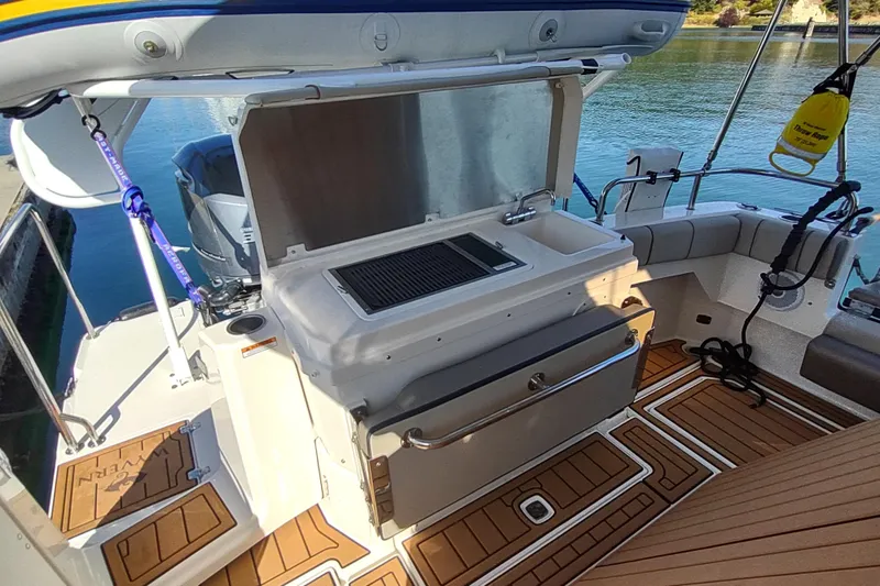 Wyvern Yacht Photos Pics 2020 Cutwater C-32 Coupe boat interior with outdoor kitchen and seating area.
