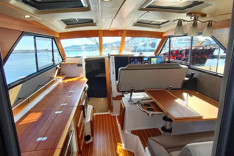 Wyvern Yacht Photos Pics 2020 Cutwater C-32 Coupe interior with wood accents and panoramic windows.