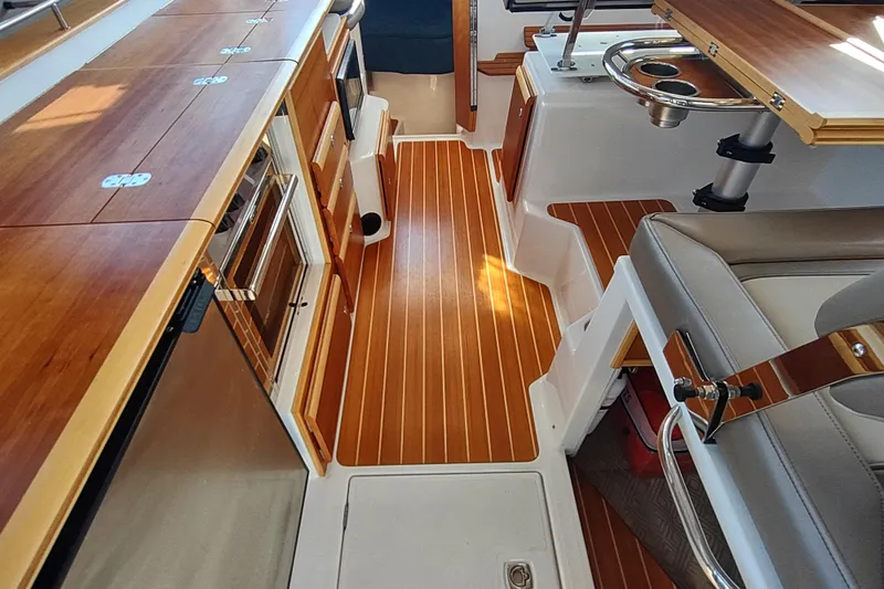 Wyvern Yacht Photos Pics Interior of 2020 Cutwater C-32 Coupe, featuring wood flooring and modern kitchen amenities.