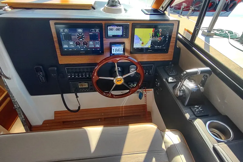 Wyvern Yacht Photos Pics 2020 Cutwater C-32 Coupe helm with navigation screens and controls.
