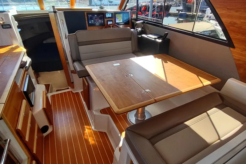 Wyvern Yacht Photos Pics Interior of 2020 Cutwater C-32 Coupe with dining area and navigation controls.