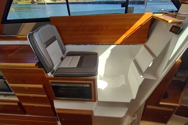 Wyvern Yacht Photos Pics Interior of 2020 Cutwater C-32 Coupe featuring seating and wooden cabinetry.