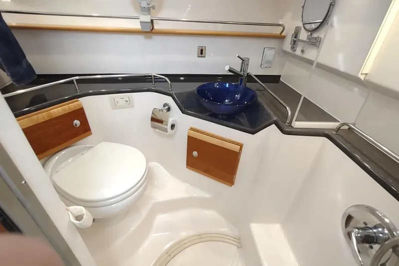 Wyvern Yacht Photos Pics 2020 Cutwater C-32 Coupe bathroom with modern fixtures and blue sink.