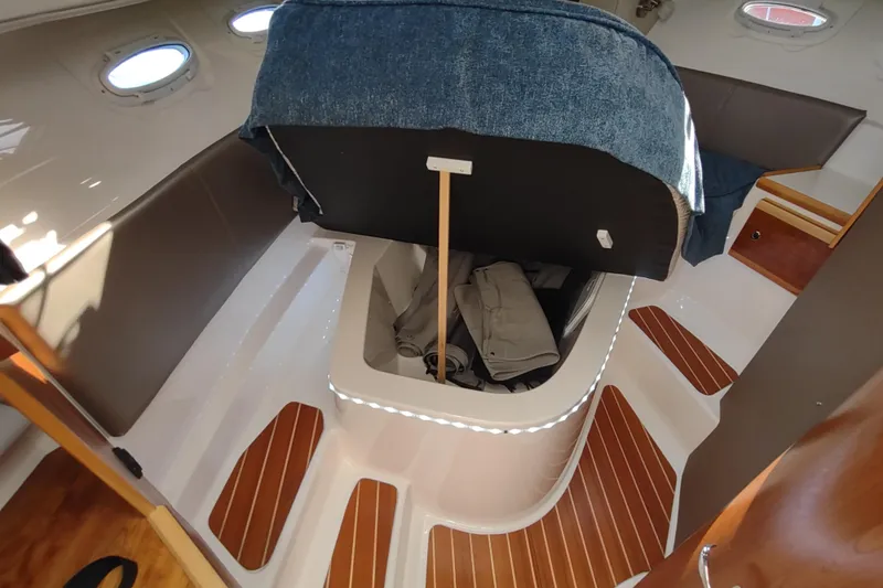 Wyvern Yacht Photos Pics Interior of 2020 Cutwater C-32 Coupe boat with storage compartment and wooden flooring.