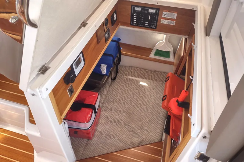 Wyvern Yacht Photos Pics 2020 Cutwater C-32 Coupe interior storage area with equipment and control panel.