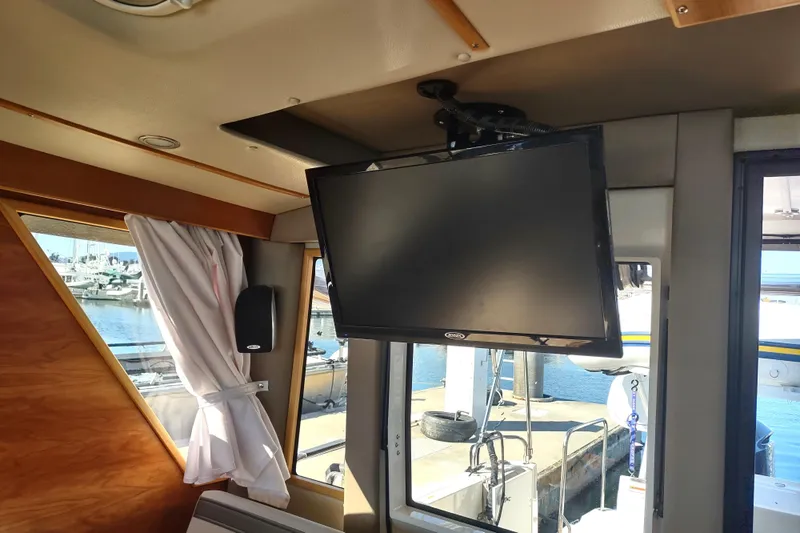 Wyvern Yacht Photos Pics Interior of 2020 Cutwater C-32 Coupe with mounted TV and marina view.