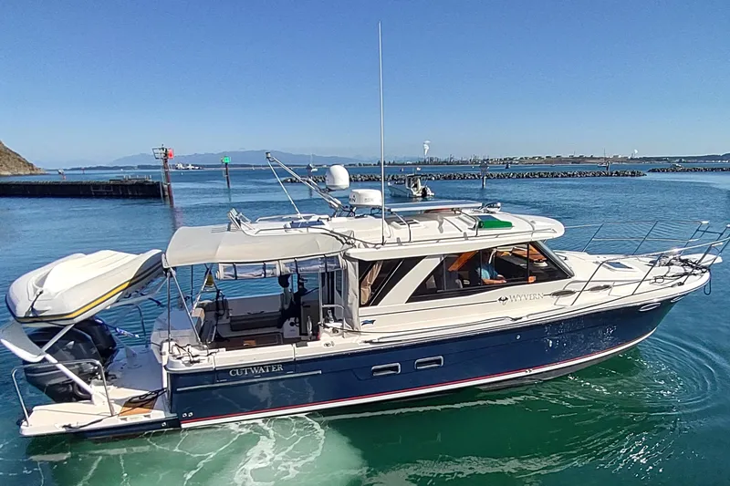 Wyvern Yacht Photos Pics 2020 Cutwater C-32 Coupe cruising on clear blue waters.