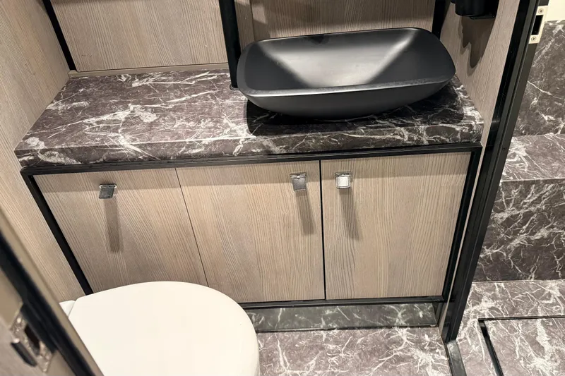  Yacht Photos Pics Luxurious bathroom interior of 2022 Cranchi A46 Luxury Tender with marble countertop and modern sink.