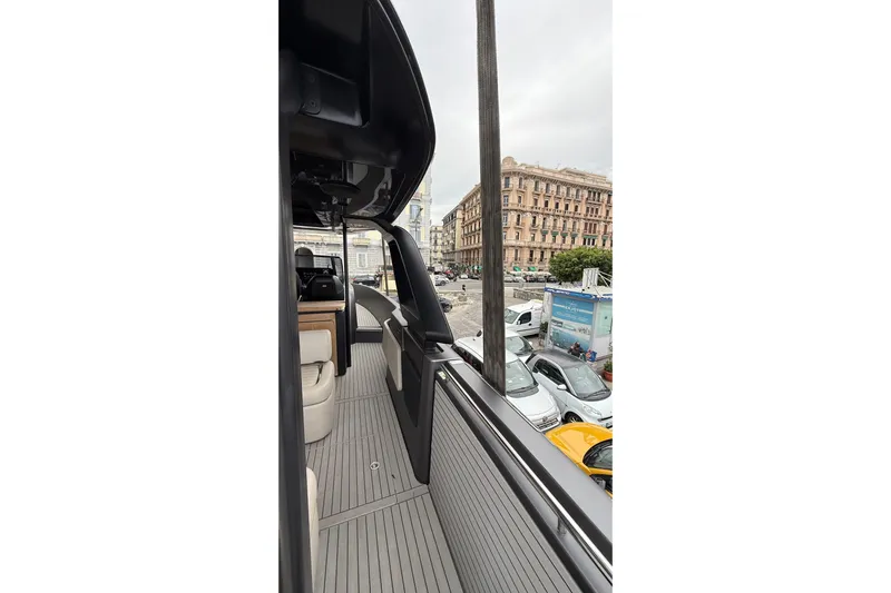  Yacht Photos Pics 2022 Cranchi A46 Luxury Tender docked in urban setting, showcasing sleek design.