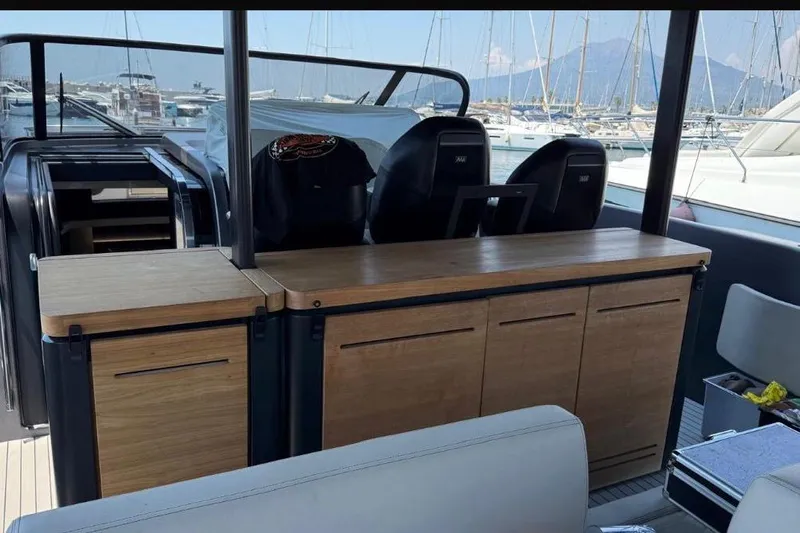  Yacht Photos Pics 2022 Cranchi A46 Luxury Tender interior with sleek wooden cabinetry and modern seating.