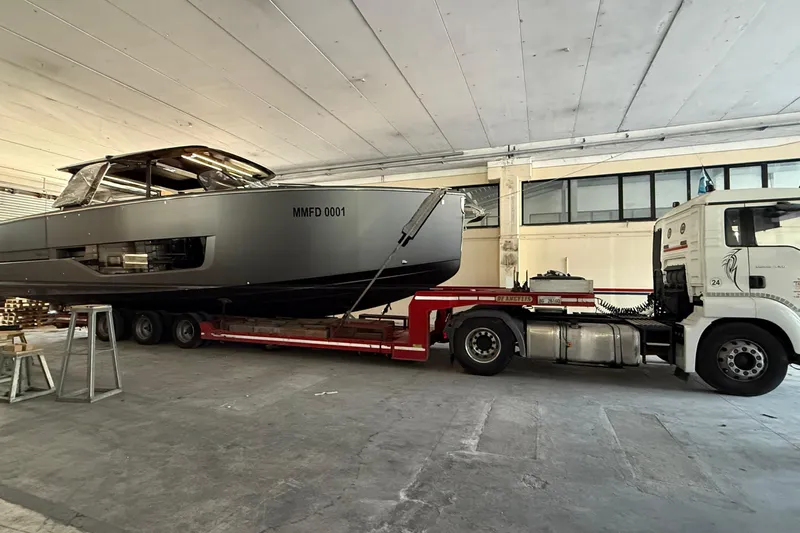  Yacht Photos Pics 2022 Cranchi A46 Luxury Tender on trailer in warehouse setting.
