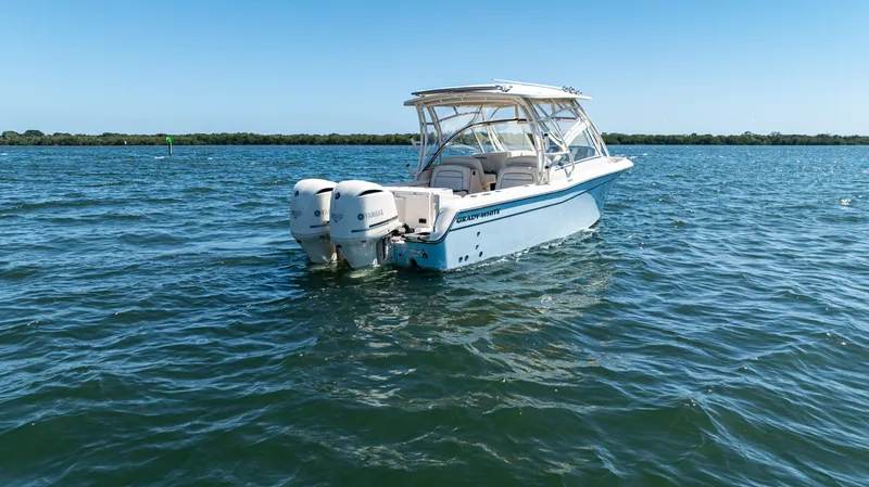  Yacht Photos Pics 2020 Grady-White Freedom 285 boat on open water under clear blue sky.