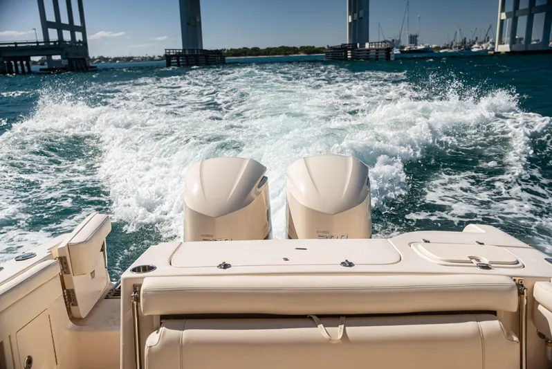  Yacht Photos Pics 2020 Grady-White Freedom 285 boat cruising with twin engines, leaving a wake.