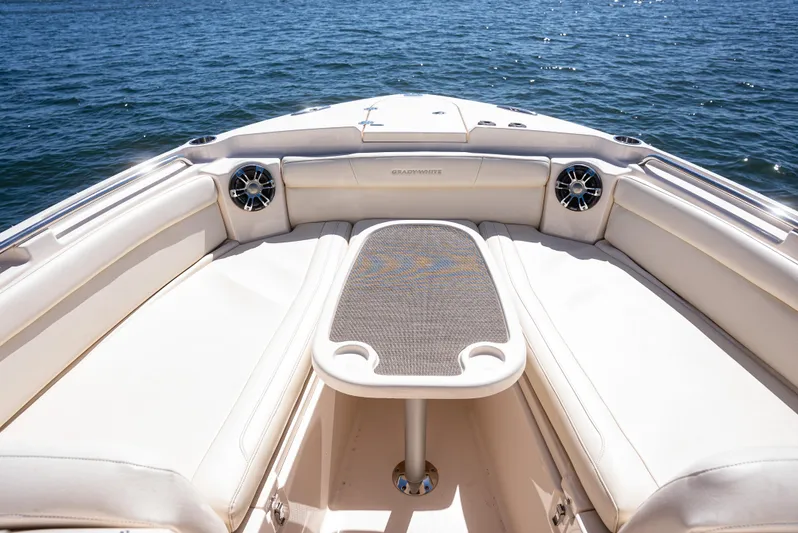  Yacht Photos Pics 2020 Grady-White Freedom 285 boat interior with cushioned seating and table on open water.