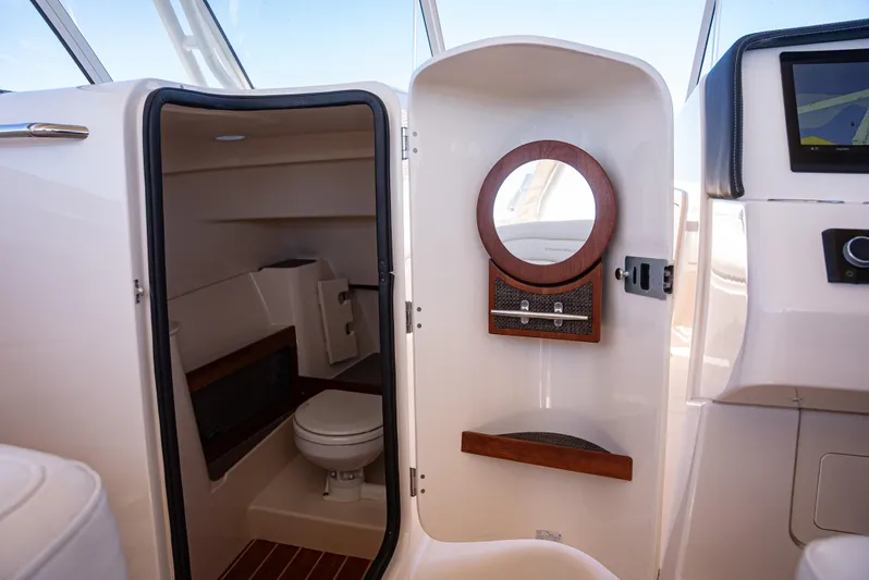  Yacht Photos Pics 2020 Grady-White Freedom 285 boat interior with compact bathroom and modern amenities.